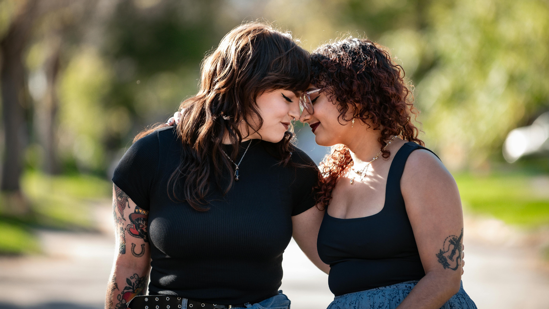 2026-01-25 LBTQ Image 5 Two lesbian women standing close together with their heads gently touching, expressing trust, understanding