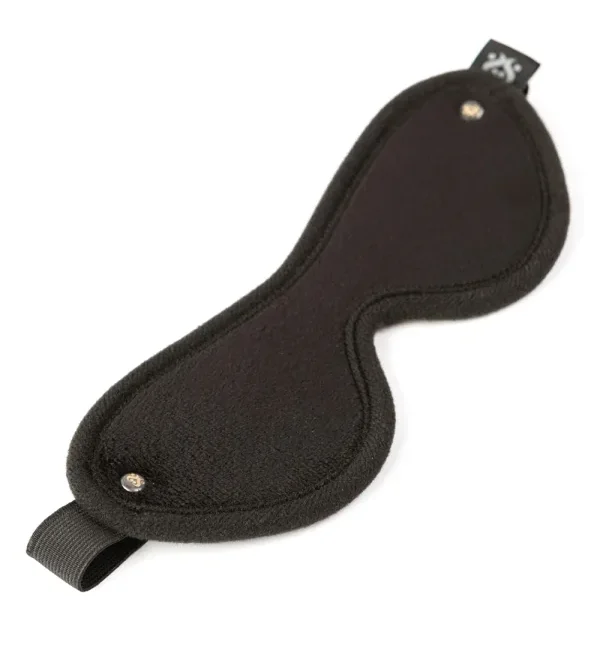 A soft BDSM blindfold used for consensual sensory play and trust-building between lesbian and LGBTQ+ partners.