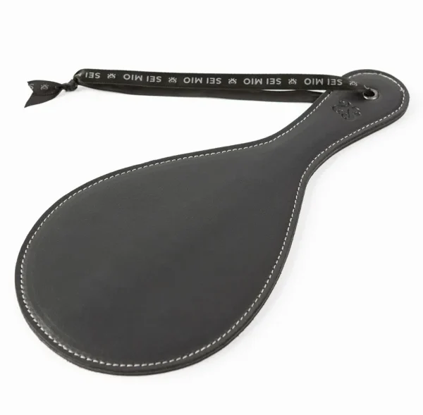 A BDSM impact paddle designed for consensual sensory play, featured as an intimacy accessory for lesbian and LGBTQ+ couples.