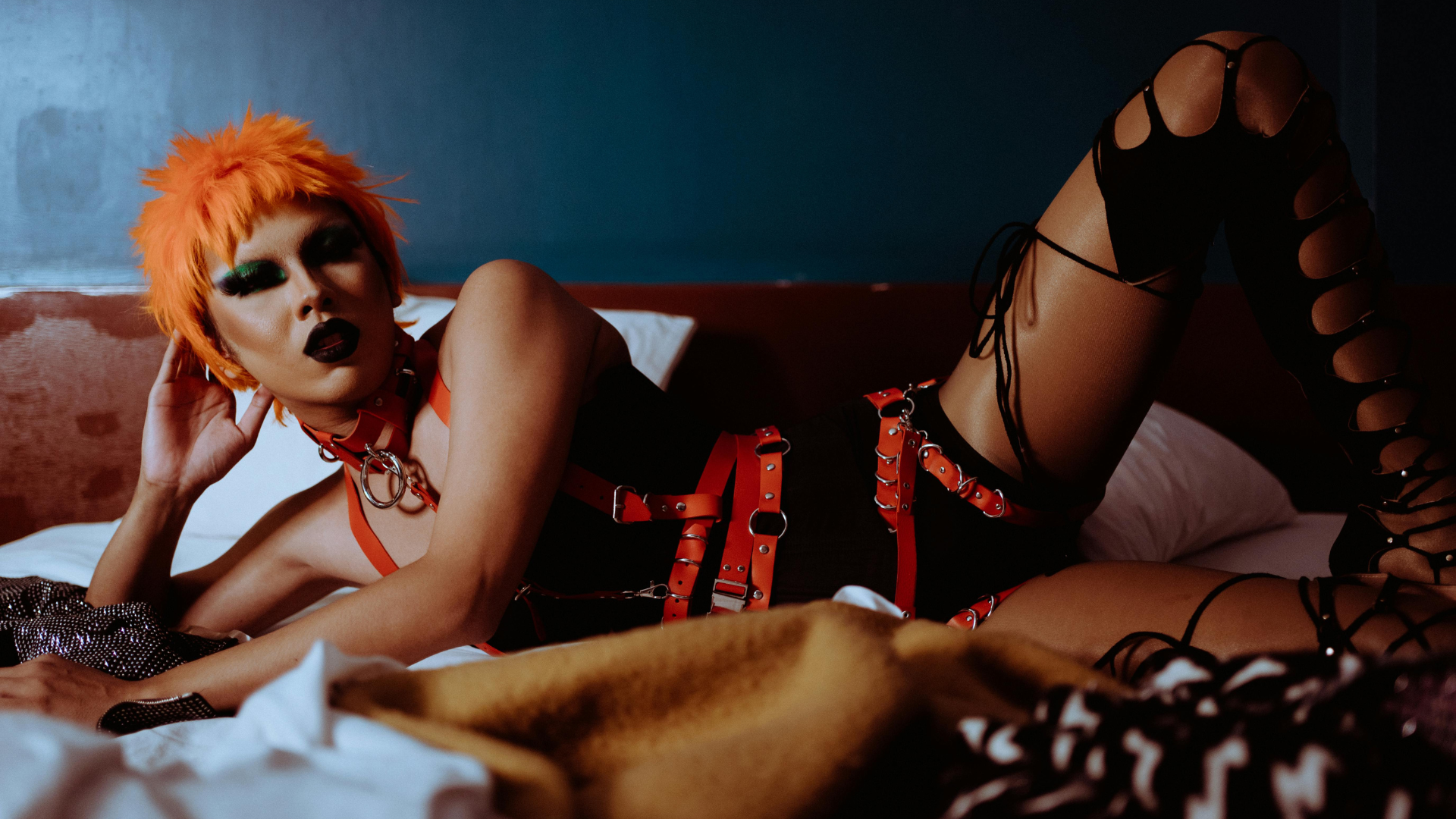 A woman in themed attire illustrating Risk-Aware Consensual Kink (RACK), promoting informed BDSM practices within the lesbian and LGBTQ+ community.